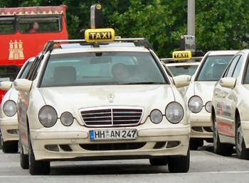 Stuttgart Taxi A line of beige taxis in Stuttgart with yellow taxi sign on the roof.