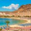 scenic beach and cliffs of Gran Canaria under a blue sky