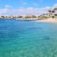 Beautiful beach of Las Cucharas in Costa Teguise, Lanzarote, Canary Islands. View of the blue sea, yellow sand, palm trees, selective focus
