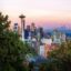 Seattle city skyline at sunset, with trees in the foreground. Seattle Airport Transfer