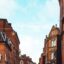 brown and red brick buildings in Leicster city in the UK, along with a cloudy sky in daytime