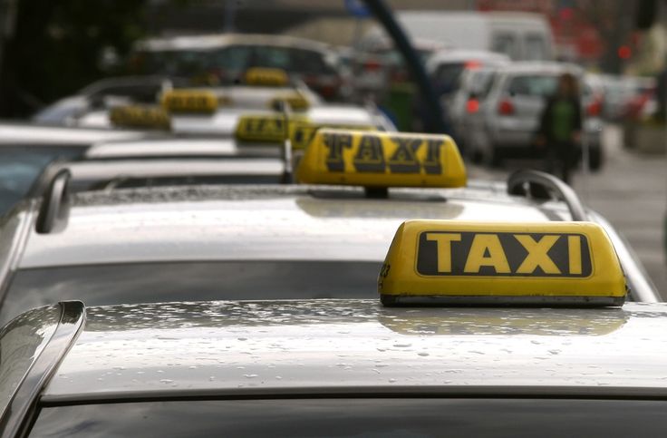 Ljubljana taxi cabs lining up with photograph focusing on taxi tops and signage