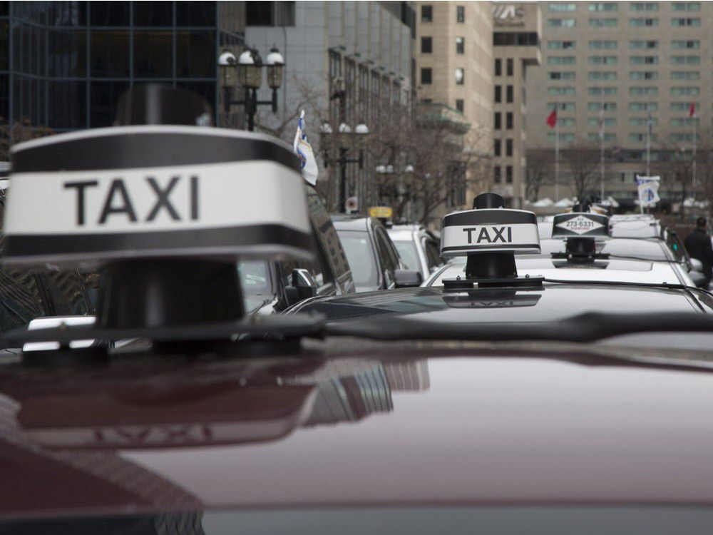 montreal-taxi montreal taxis lining up in the street, photo focusing on cab tops and signage