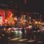 red orange and yellow neon signs on a busy street in downtown Nashville
