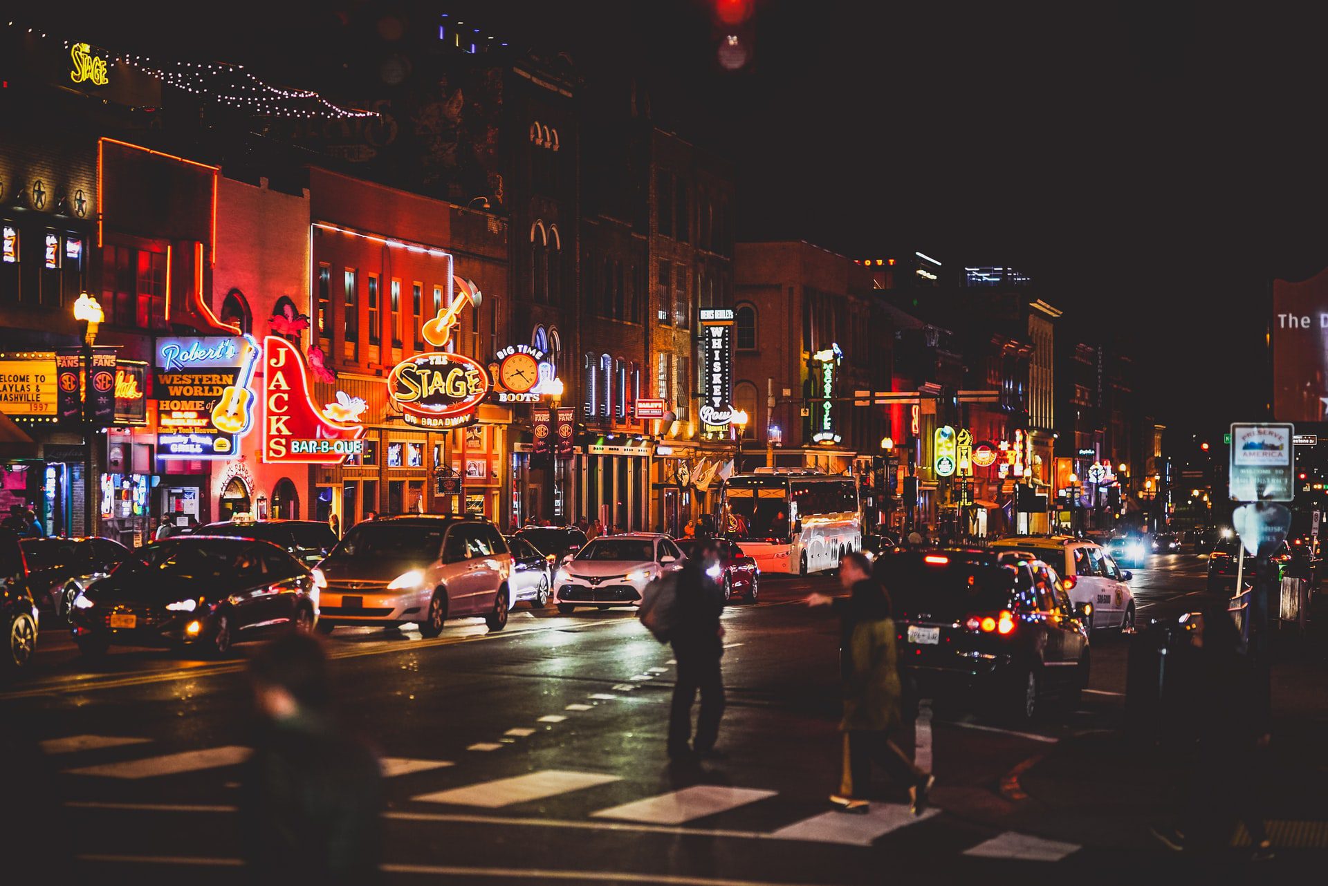 Downtown Nashville red orange and yellow neon signs on a busy street in downtown Nashville