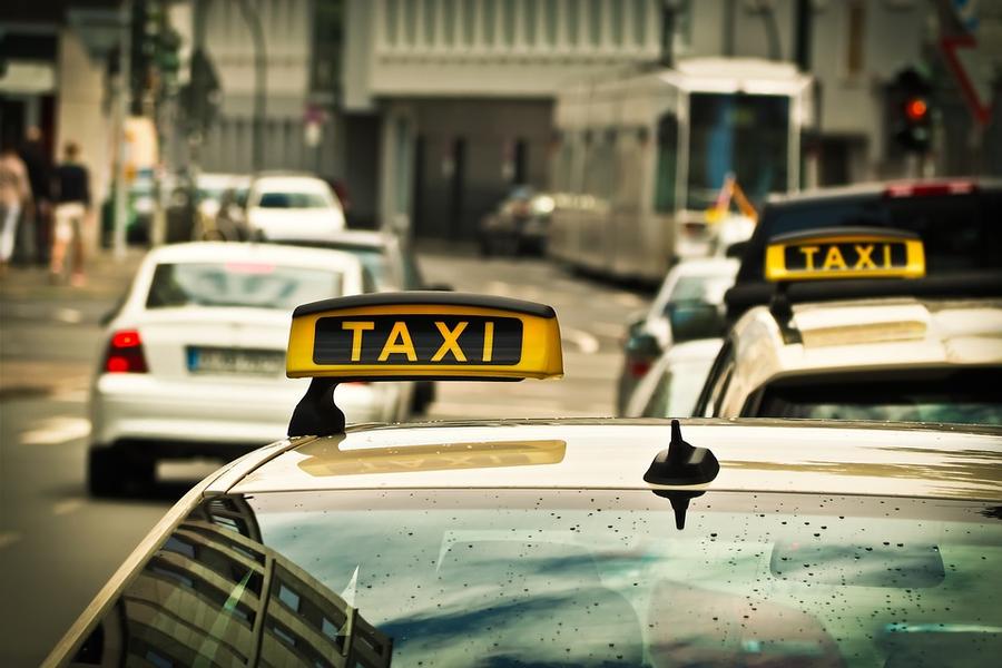 Phoenix taxi street with cars and taxis standing out, signature yellow and black taxi signage in Phoenix