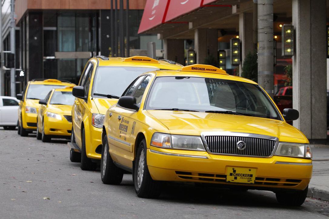 Calgary cabs yellow taxis lined up in cab rank in Calgary