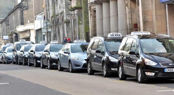 Inverness taxi rank black and silver cabs lined up in a taxi rank by the pavement