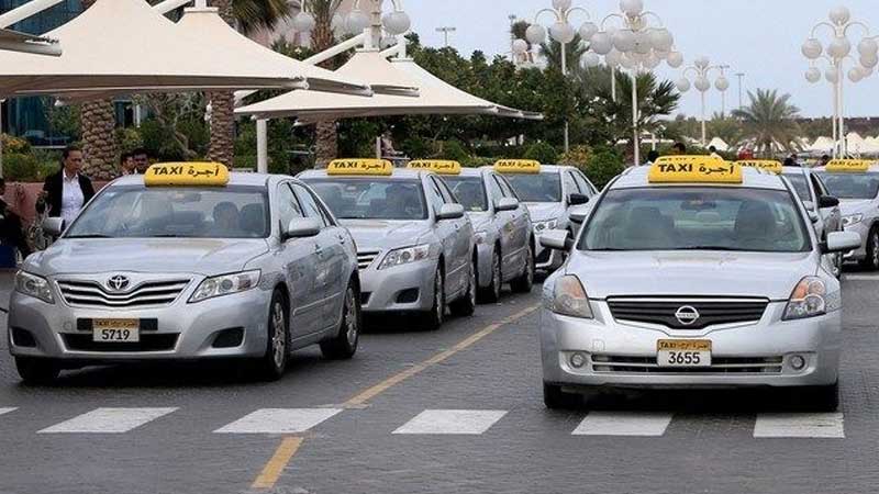 Abu Dhabi taxi silver taxis with swignature yellow roof sign