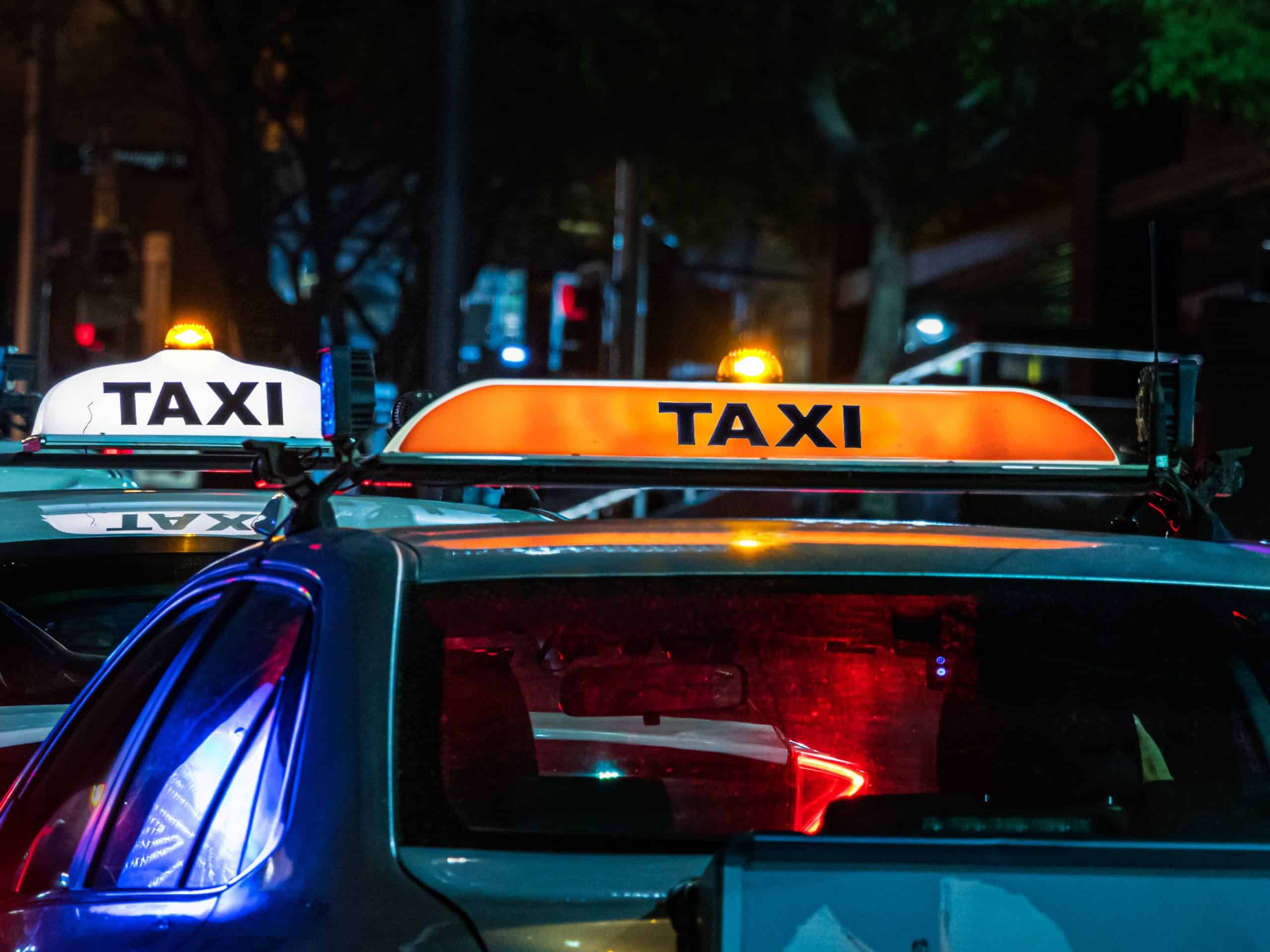 Indianapolis Taxi two taxis photographed at night with signature sign on roof