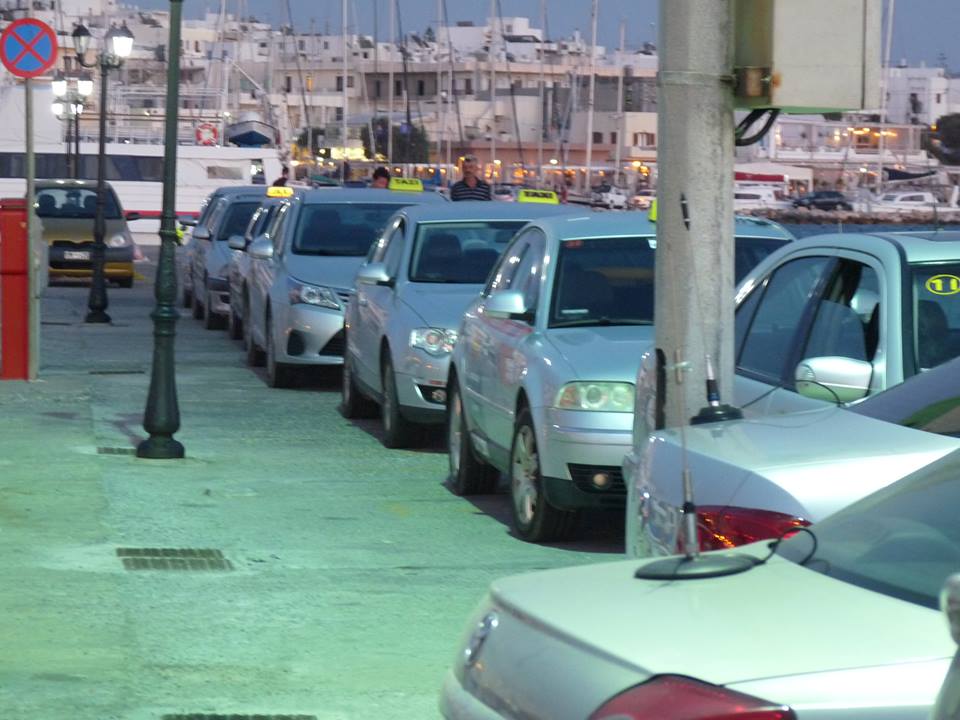 Naxos taxi silver taxis with yellow signature sign on their roof lining up at a taxi rank