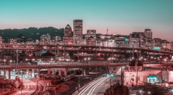 aerial post sunset long exposure shot of city lights and tall buildings