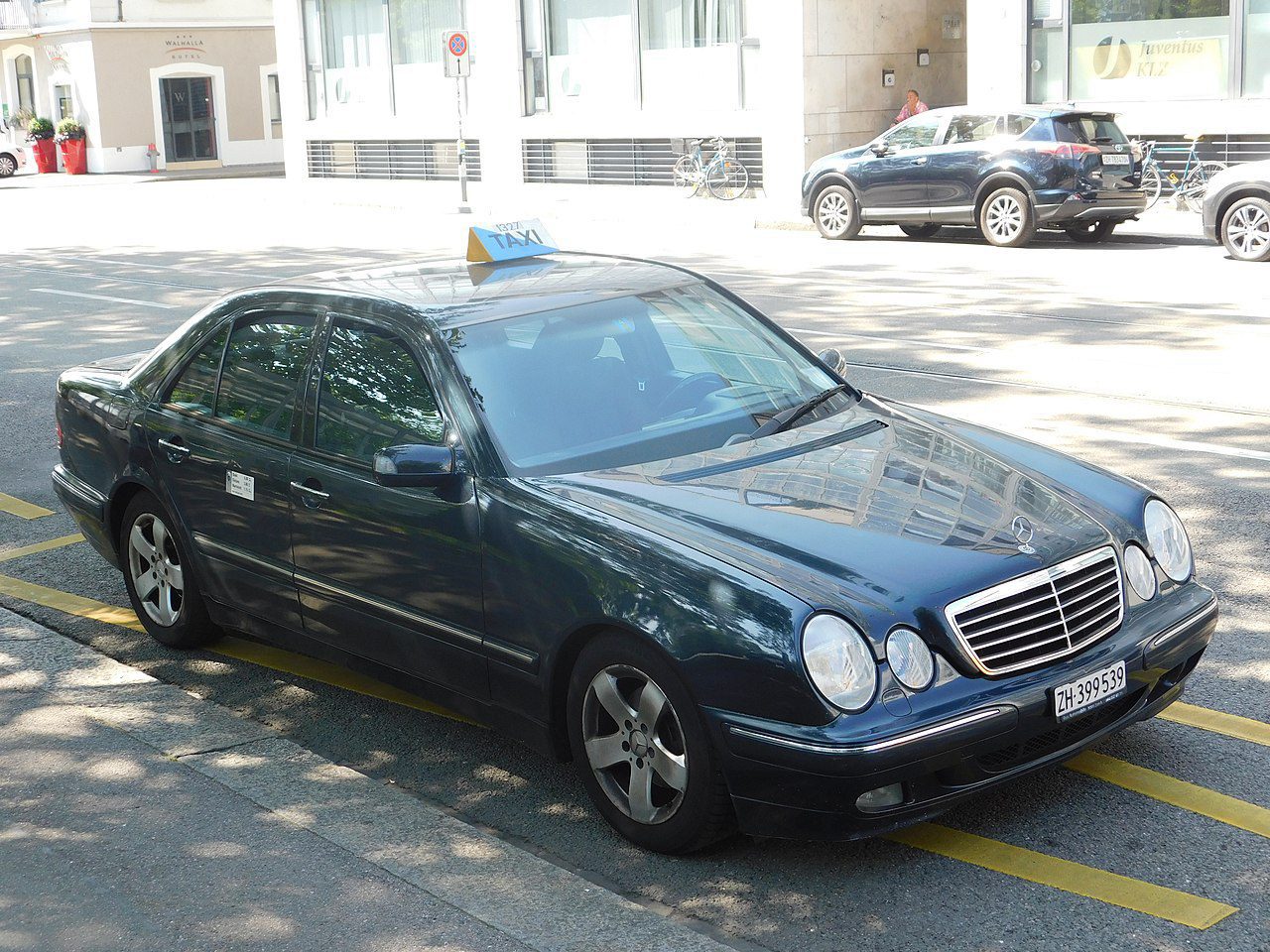 Taxi service Zurich black vehicle with a signature taxi sign on the roof