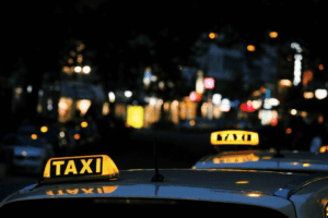 Atlanta taxi rank lighted yellow taxi signs on cab roofs and blurred city lights at distance