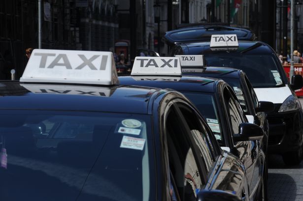 Cardiff taxi black taxis with signature white and black roof sign lining up in a cab rank