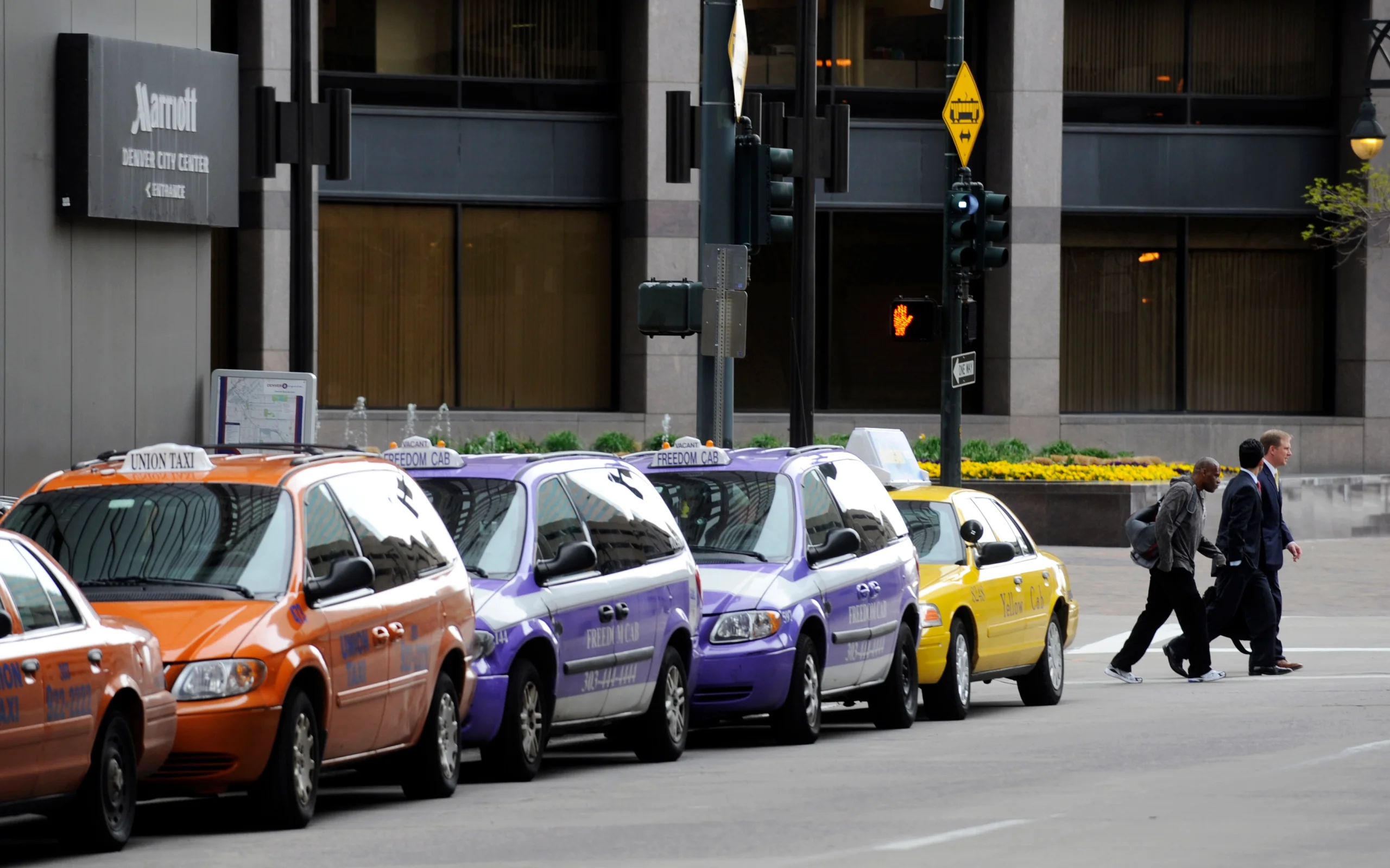 denver taxi yellow purple and orange taxis lining up at taxi rank