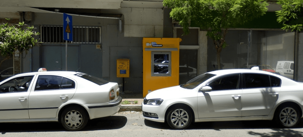 Kalamata taxi two white taxis in Kalamata by the curbside