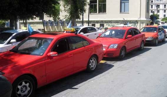 Kavala taxi lines of red and white taxis with signature yellow and black sign on top