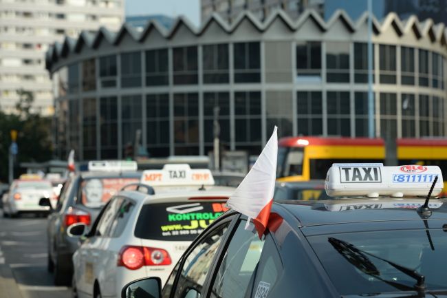 Warsaw taxi taxis with signature roof signage in the streets of Warsaw