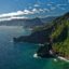 blue green sea waters and green hills under a cloudy sky in the Madeira Islands of Portugal