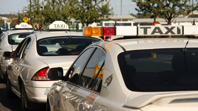 Canberra taxi signature taxi signs on three white vehicles' roofs