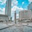 high and low rise city buidlings surrounding a fountain