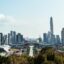daytime shot of skyscrapers and modern city buildings and green trees