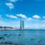 skyscrapers and other city buildings near body of calm water under a blue cloudy sky