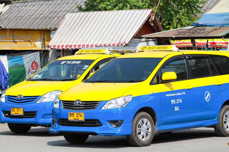 chiang mai taxi two yellow and bright blue taxis with a signature roof sign in yellow