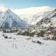 snowy ski resort and mountains under a cloudy sky