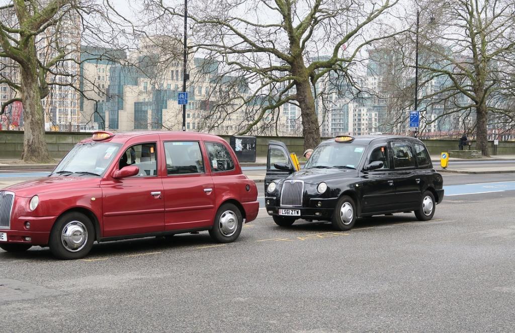 Sheffield taxi wine-red and black cabs with signature yellow 'taxi' sign at the front