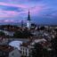 shades of blue and pink in the sky above the old town building roofs in Tallinn, Estonia