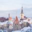 snowy city building roofs under a cloudy sky