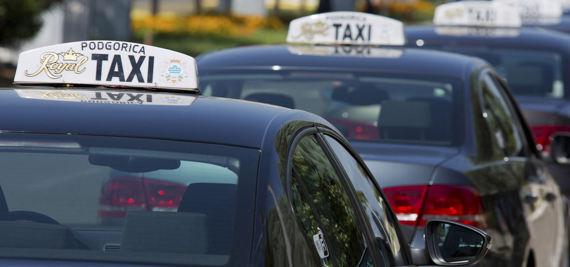 Podgorica, taxi black taxis photographed from the back with their signature taxi sign on the roof