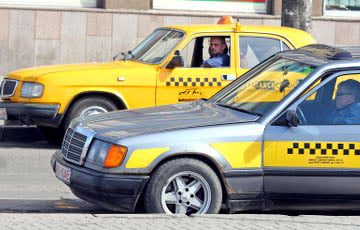 minsk taxi a yellow and a grey taxi side by side with a checker detail ont he side under the front window