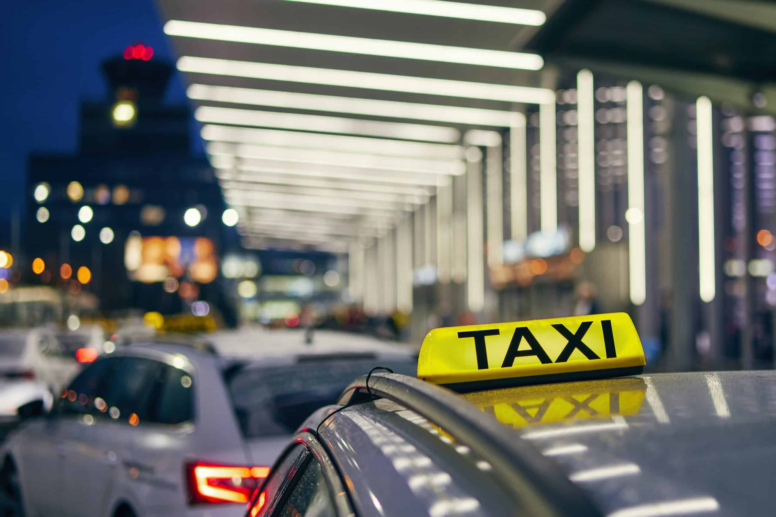 rotterdam taxi lighted yellow taxi sign with black letters on the roof of a car