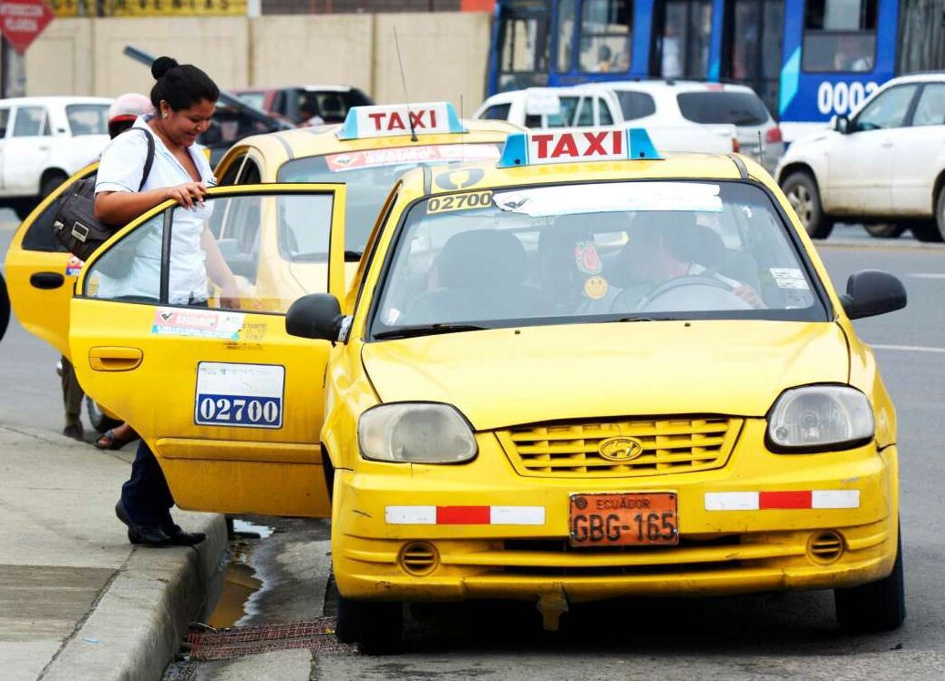 Taxi in Quito Official yellow taxi in Quito taking a passengers from the street