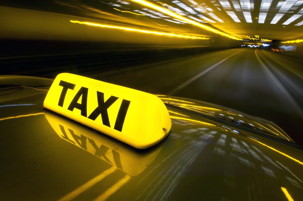 Tulsa Taxi Cab A Cab At High Speed On A Motorway at Nighttime with a LIghted Yellow Taxi Sign