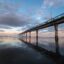 view under the pier at Christchurch under a blue and orange sunset sky