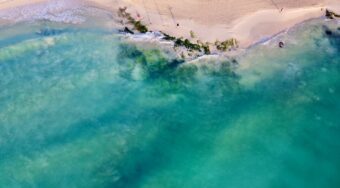 Aerial sea view of the turquoise water and golden sand in Playa del Carmen