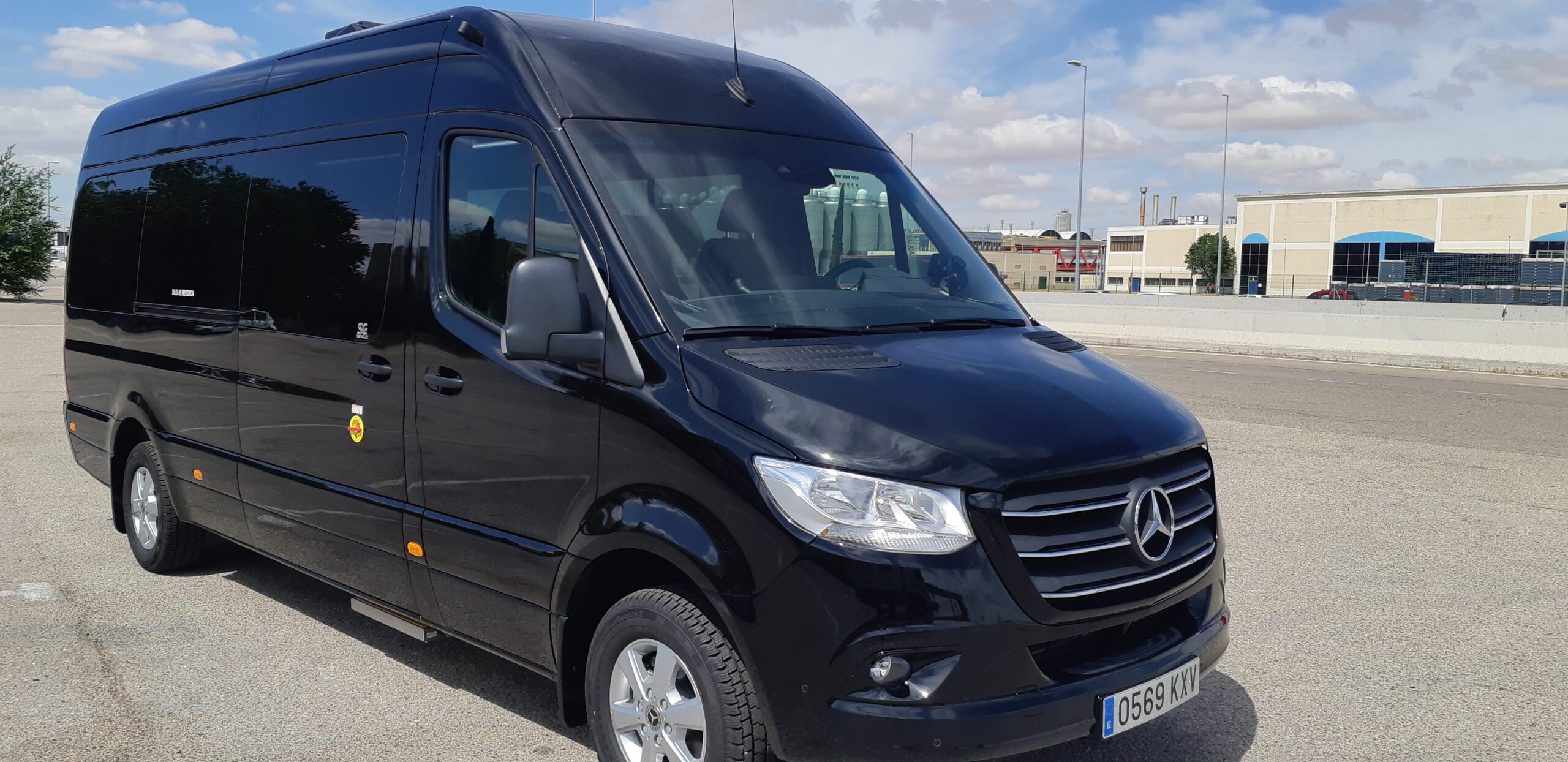 Side view of a black Barcelona Airport taxi (minivan).