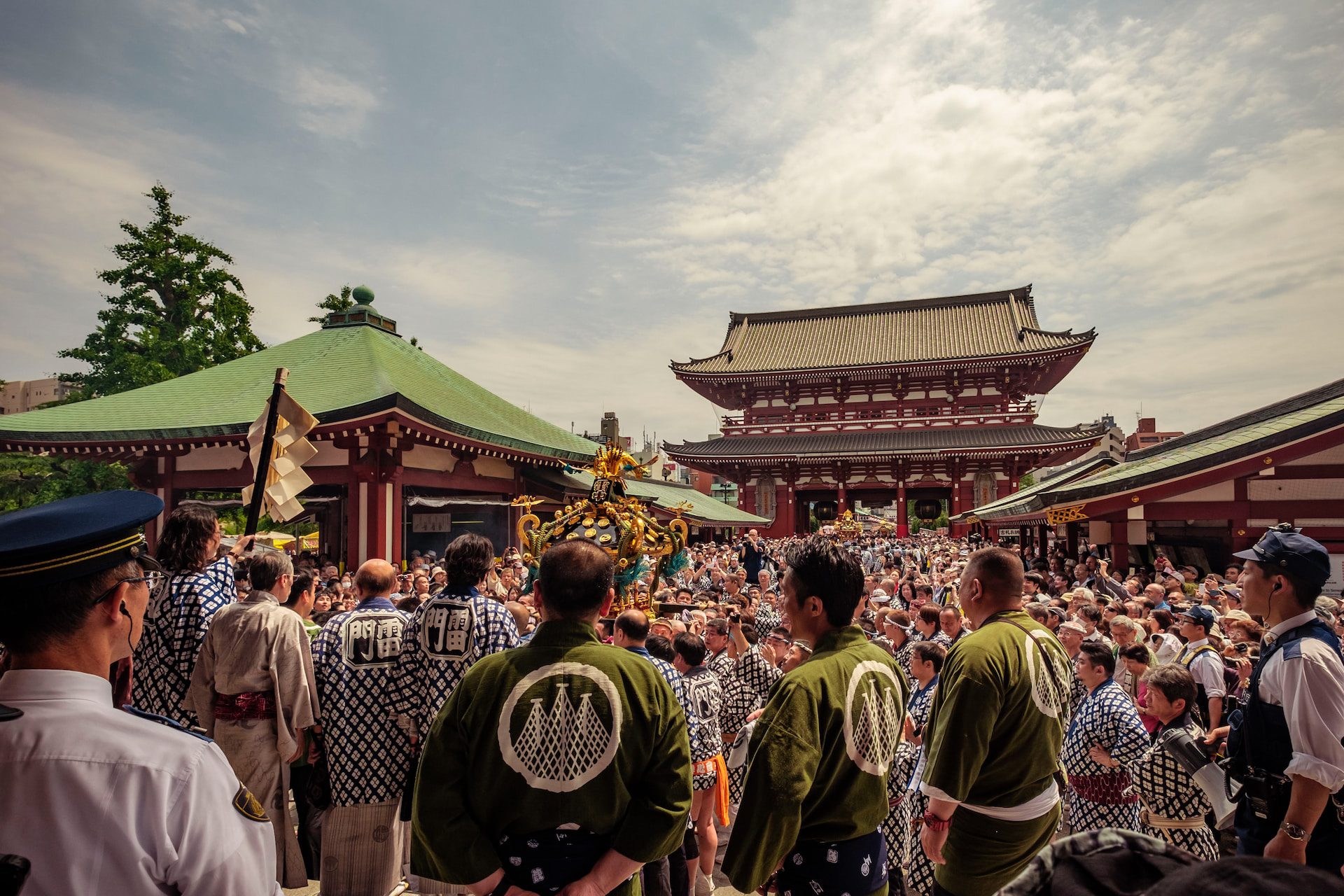 A crowd of people celebrating Sanja Matsuri outside of Senso-ji Temple in Tokyo.