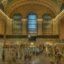 A view of the interior to grand central station with a wide corridor and tall arches