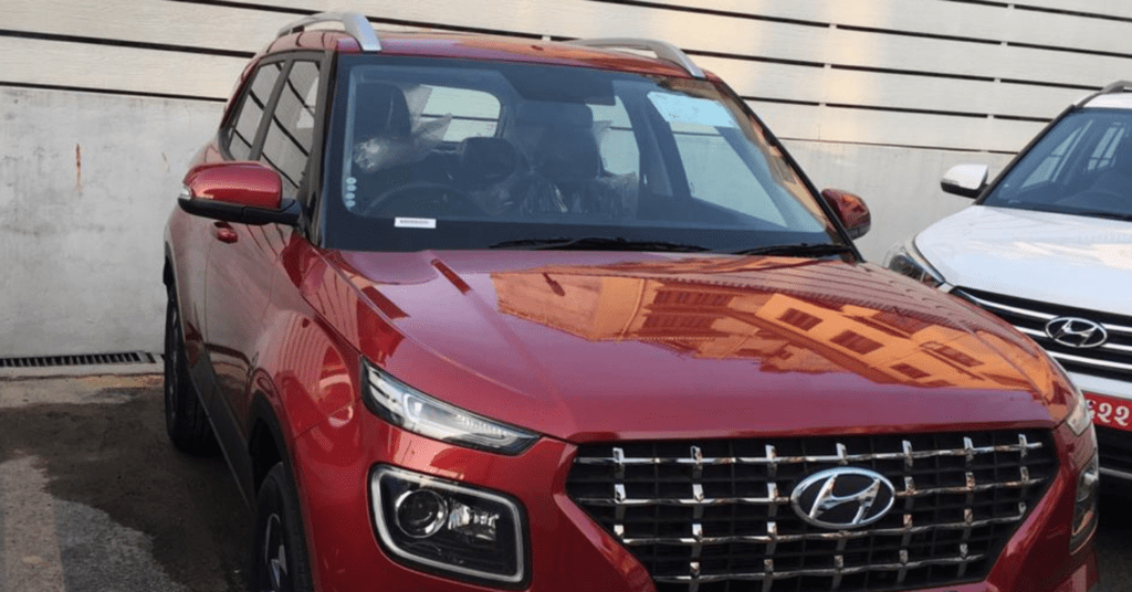 A red Hyundai Kathmandu Airport taxi sedan