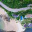A bird's eye view of a resort next to a road and a beach on Koh Lanta island.