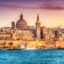 A view of the old city of Valletta in Malta with the ocean in the foreground..