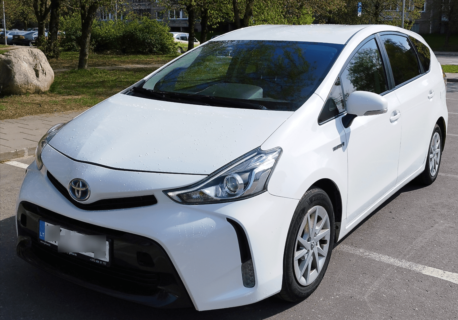 A white Vilnius Airport Taxi Sedan.
