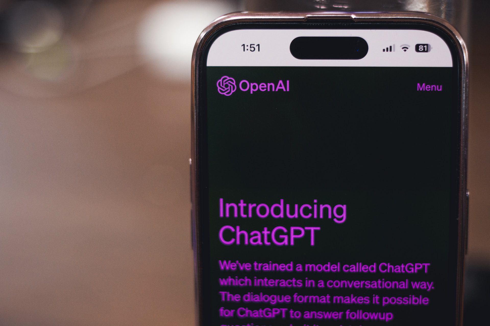 A photo of a smart phone with Open AI Chat GPT on the screen.