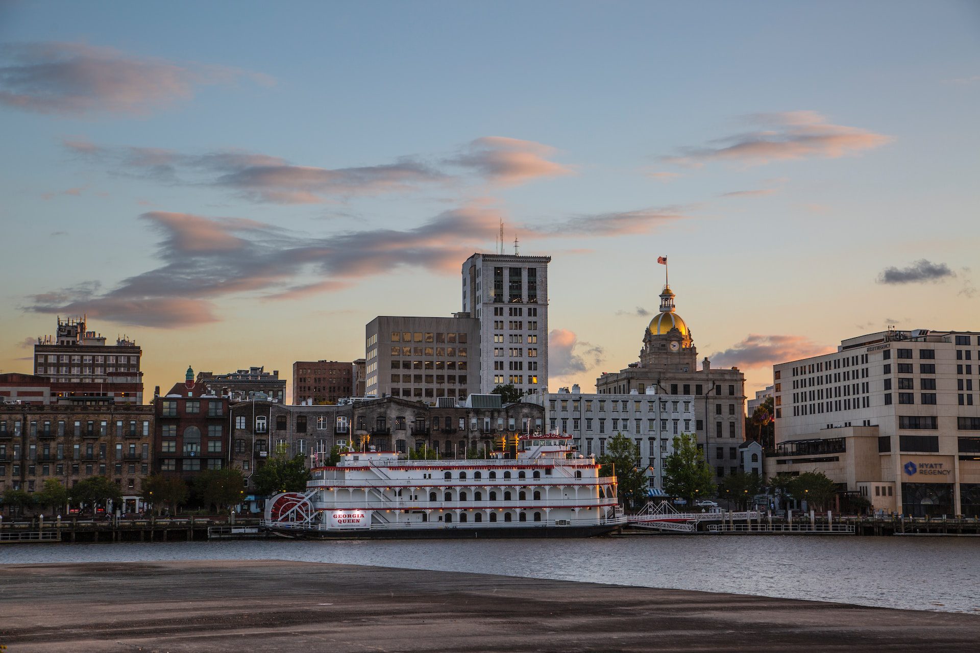 View of the Savannah River with a riverboat cruise boat docked on River Street.