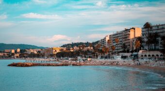 A sandy beach with blue waters and